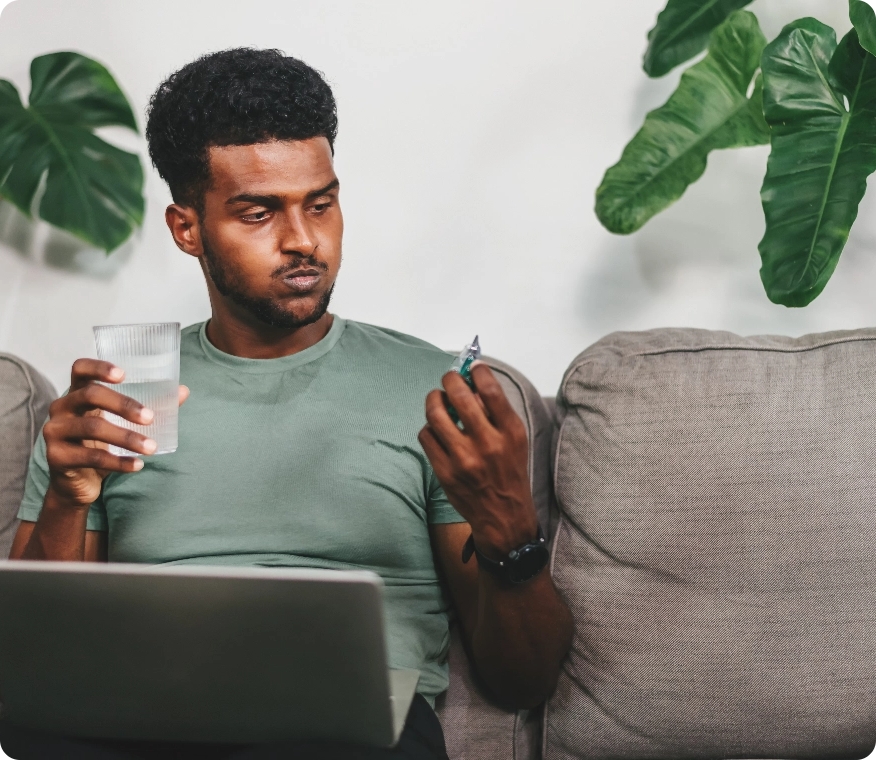 african-man-taking-medication-male-holding-pills-2023-06-21-04-21-38-utc@2x