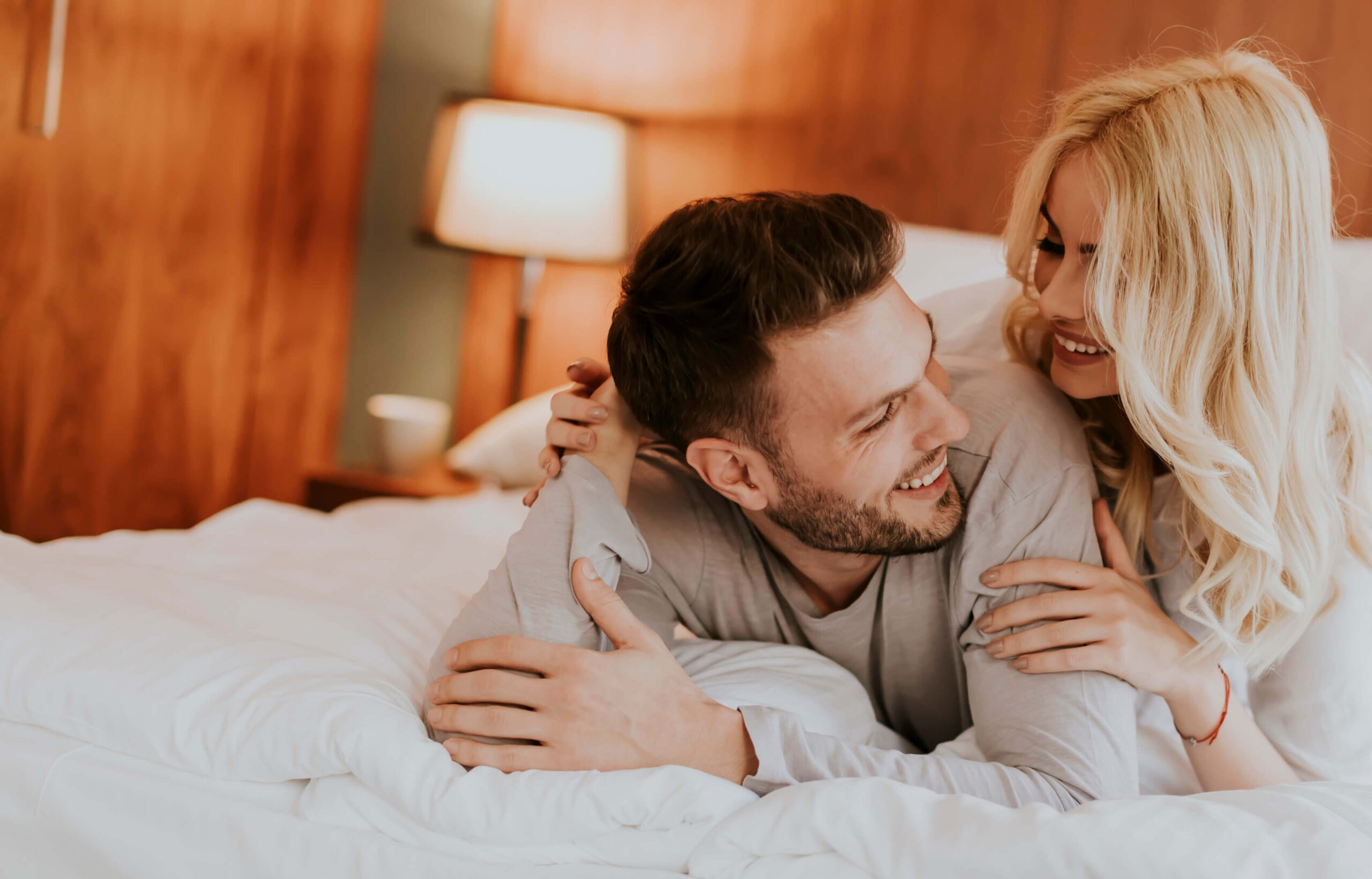 romantic-couple-in-love-lying-in-bed-together-2022-04-06-00-51-49-utc-1-scaled